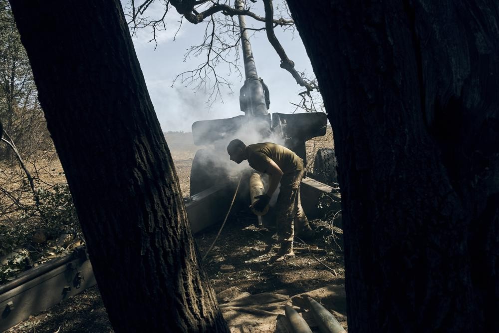 A Ukrainian soldier fires on the front line in the Donetsk region, eastern Ukraine, Sat. Sept. 3, 2022. (AP Photo/Kostiantyn Liberov)